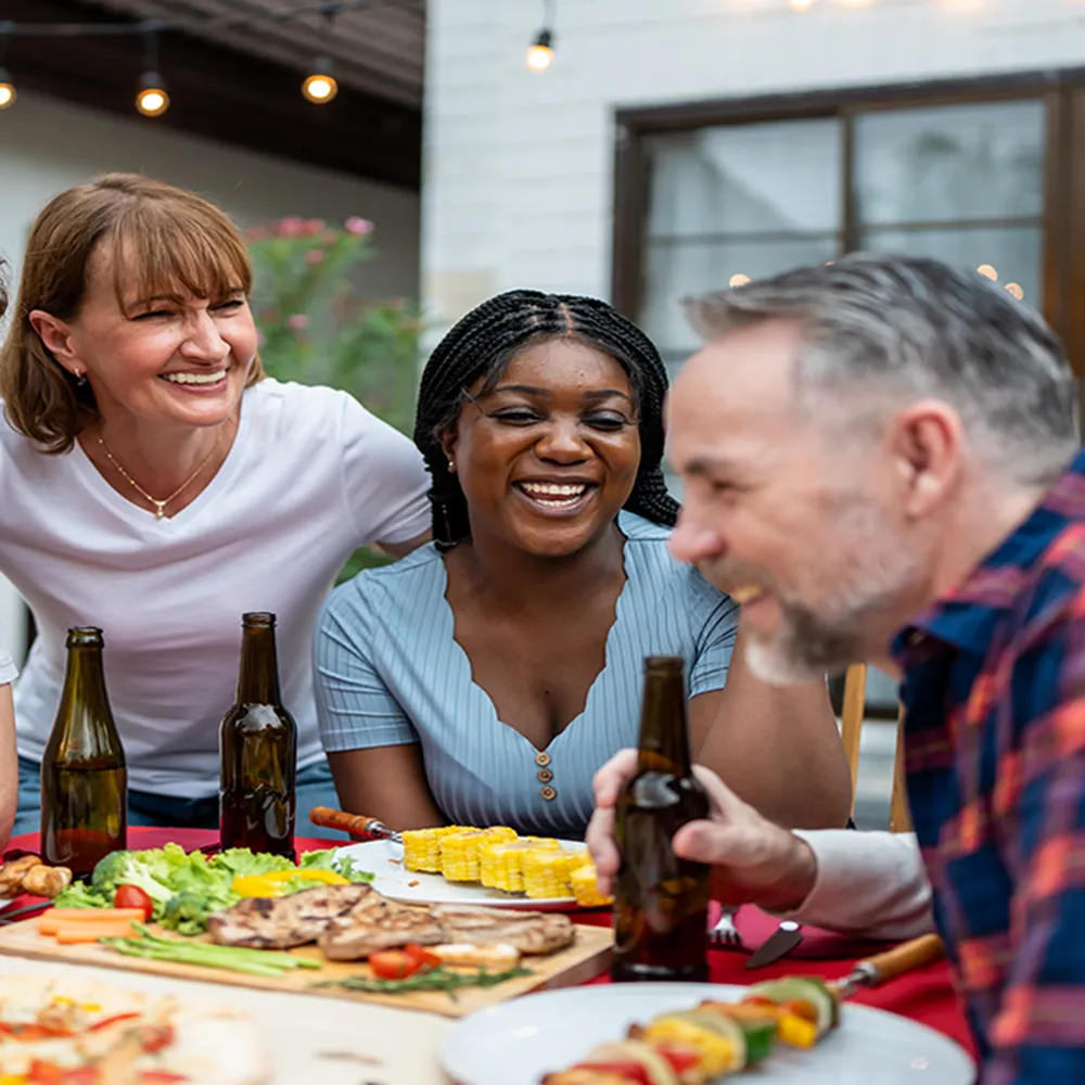 smiling family laughing around dinner table
